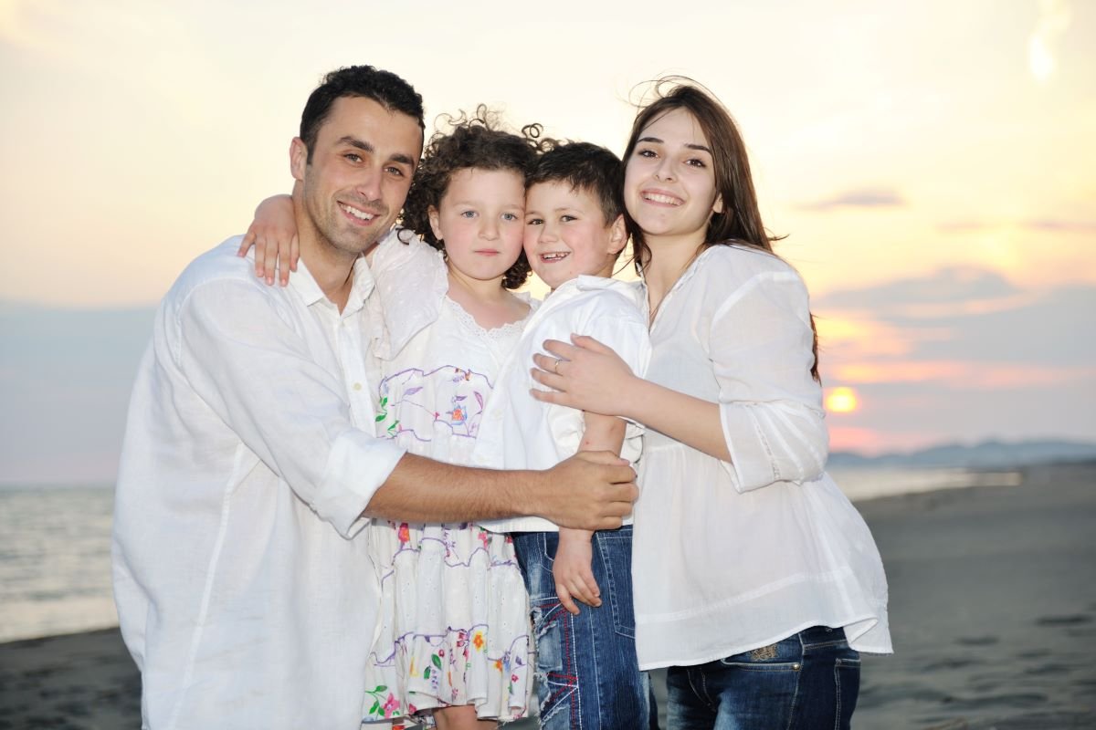 UAE Family Visa_happy-young-family-have-fun-on-beach UAE Family Visa_happy-young-family-have-fun-on-beach